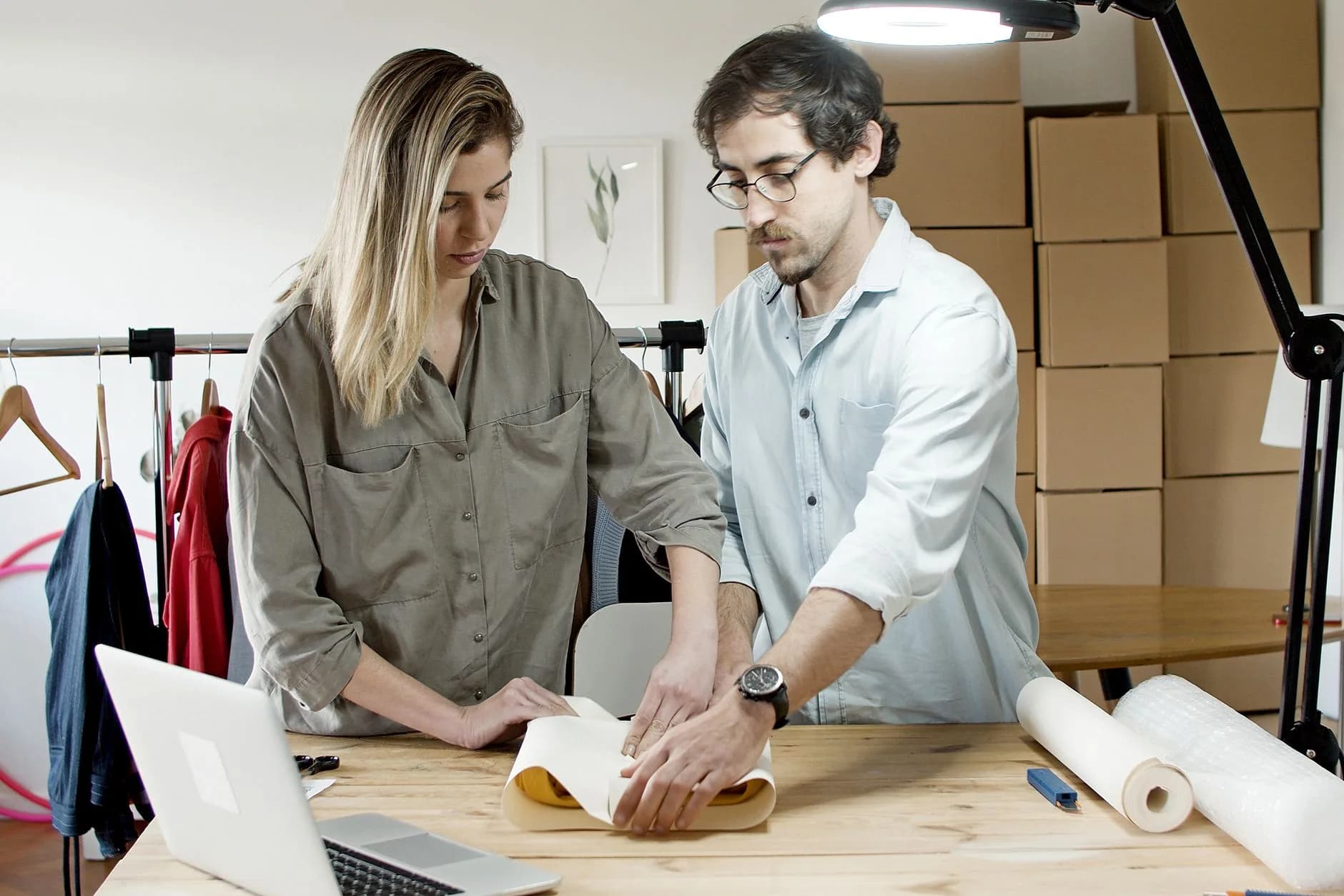 Team members packing orders in an online store's workspace, exemplifying efficient teamwork.